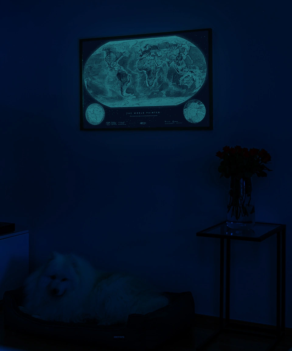 The same room with the lights off: the map glows softly in the dark